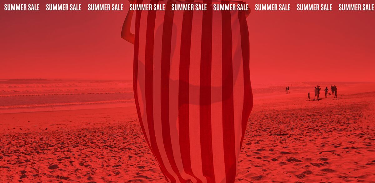 Beach scene with a striped towel in the foreground under a red overlay.