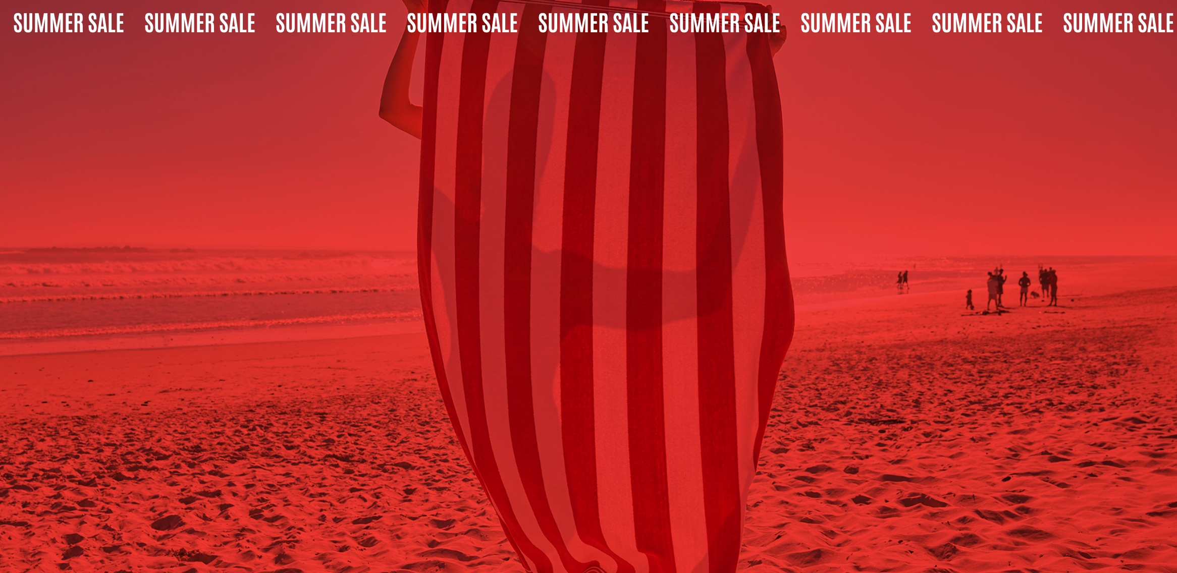 Beach scene with a striped towel in the foreground under a red overlay.