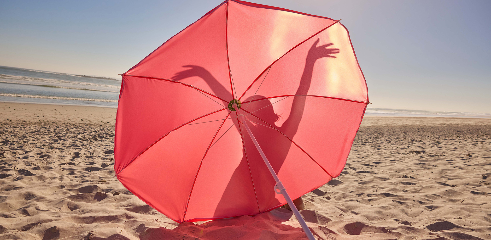 Pink umbrella on a beach
