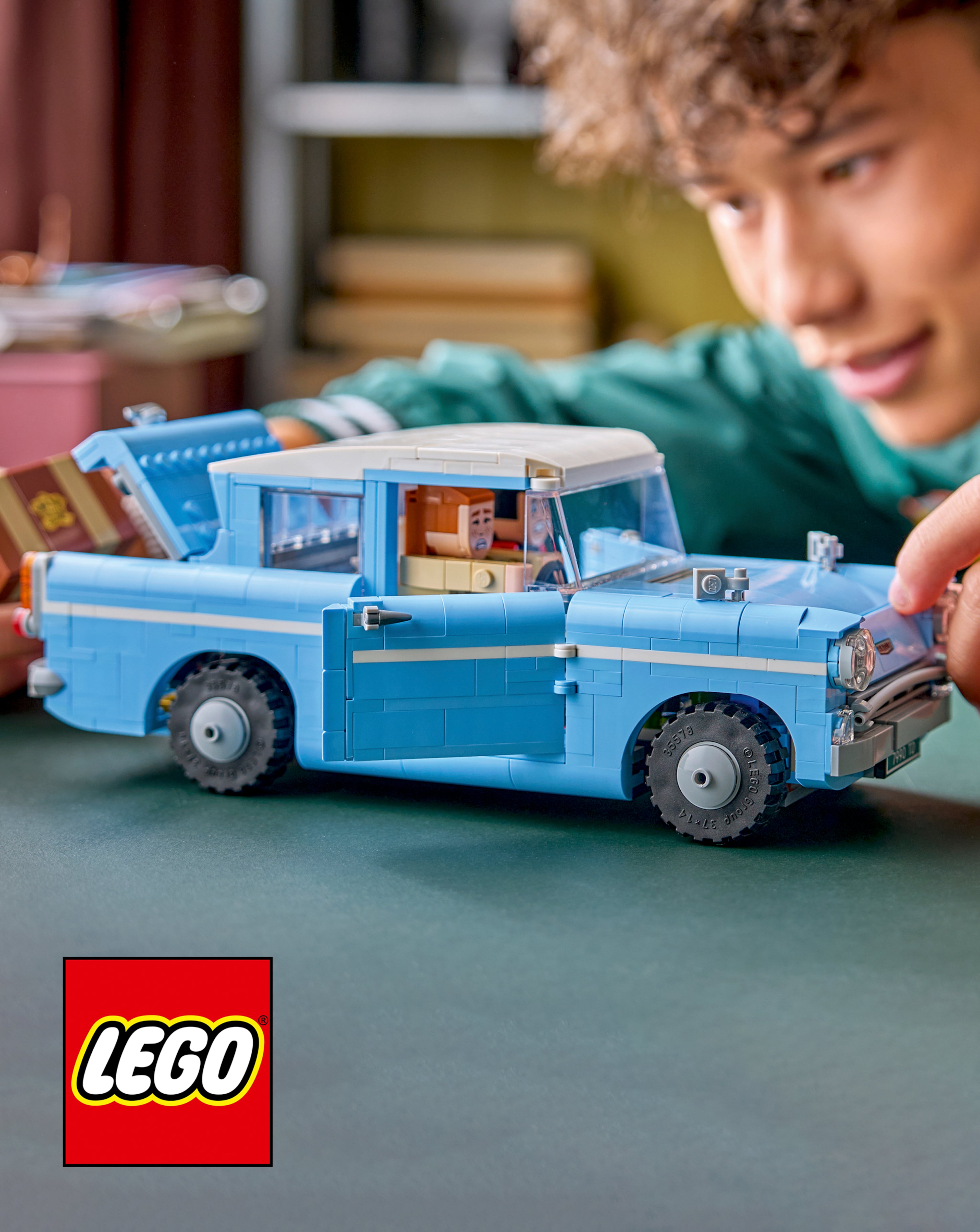 A person building the LEGO Harry Potter Enchanted Flying Ford Anglia.