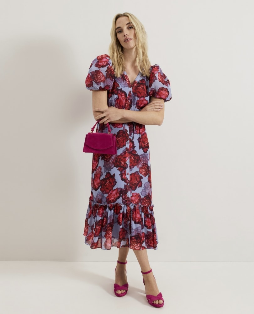 Pretty lady in flowery dress. Flower Dress. red handbag. Mother of the bride. Occasion wear 