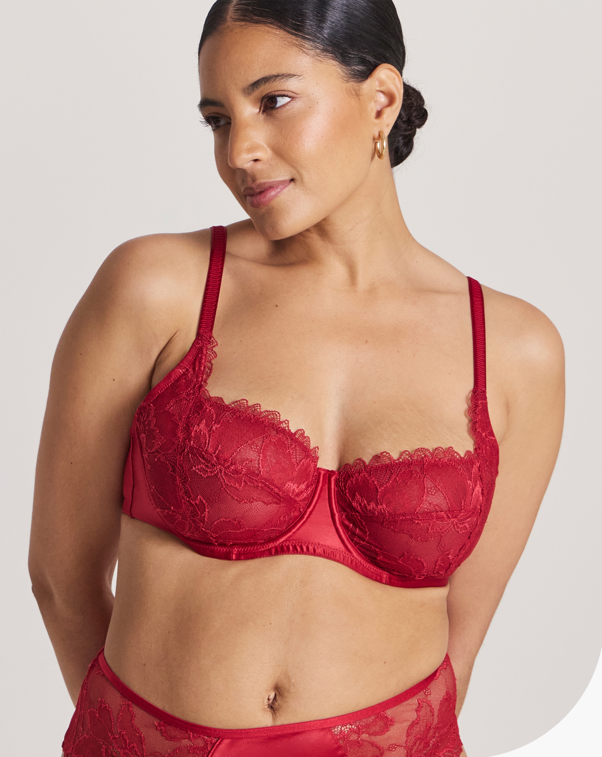 Model wearing a red Pretty Secrets balcony bra.