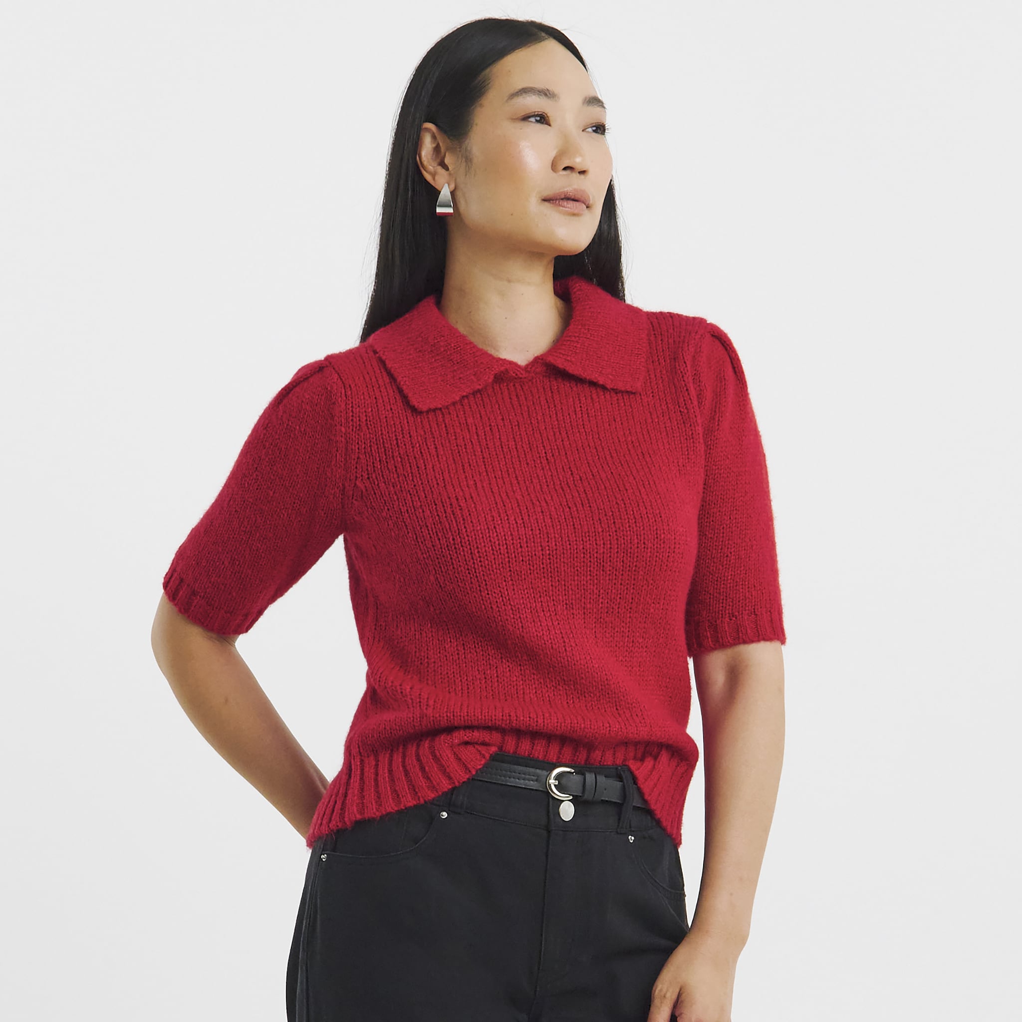 Lady wearing a red knitted short sleeve top.