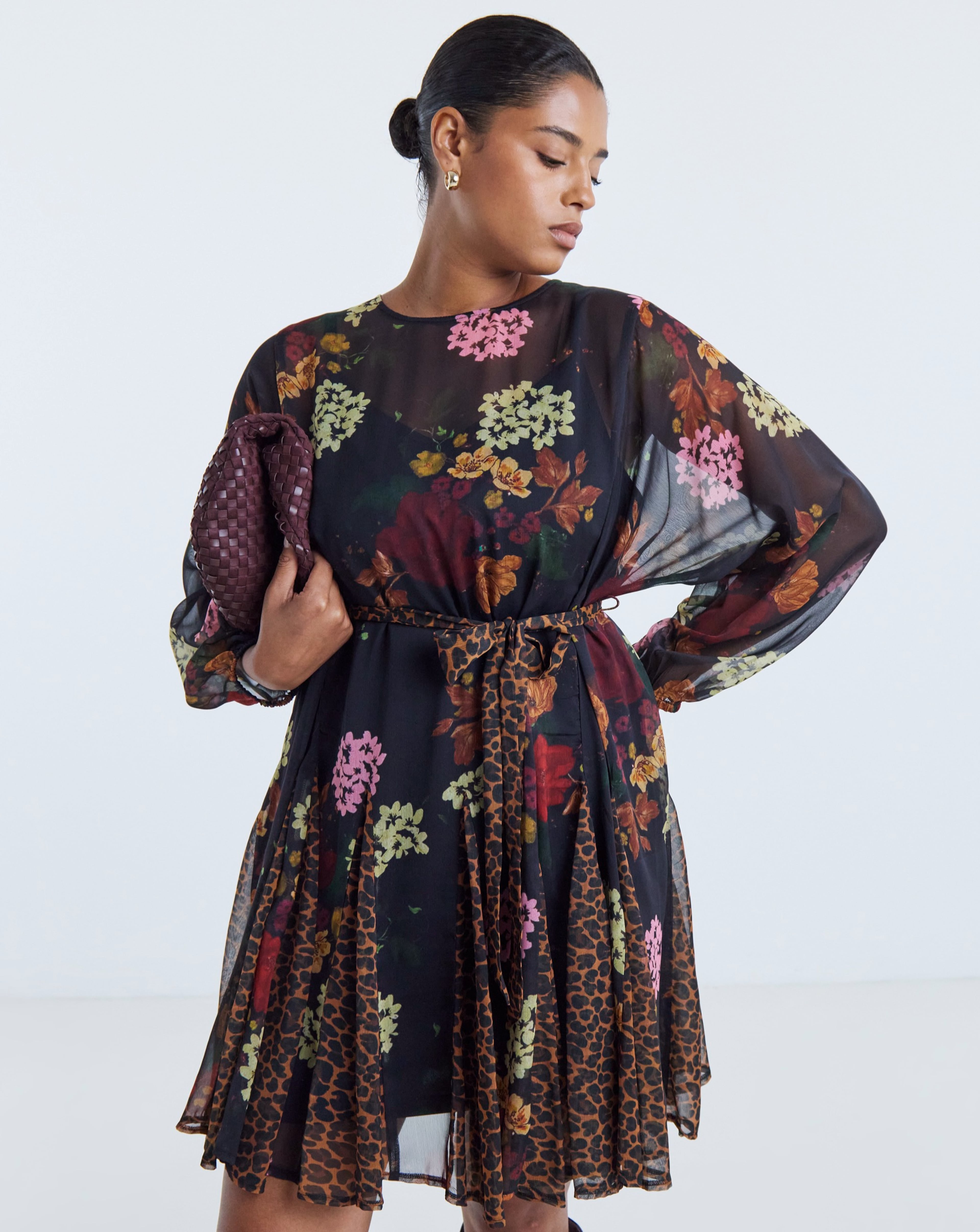 Person wearing a Simply Be mixed print long sleeve dress.