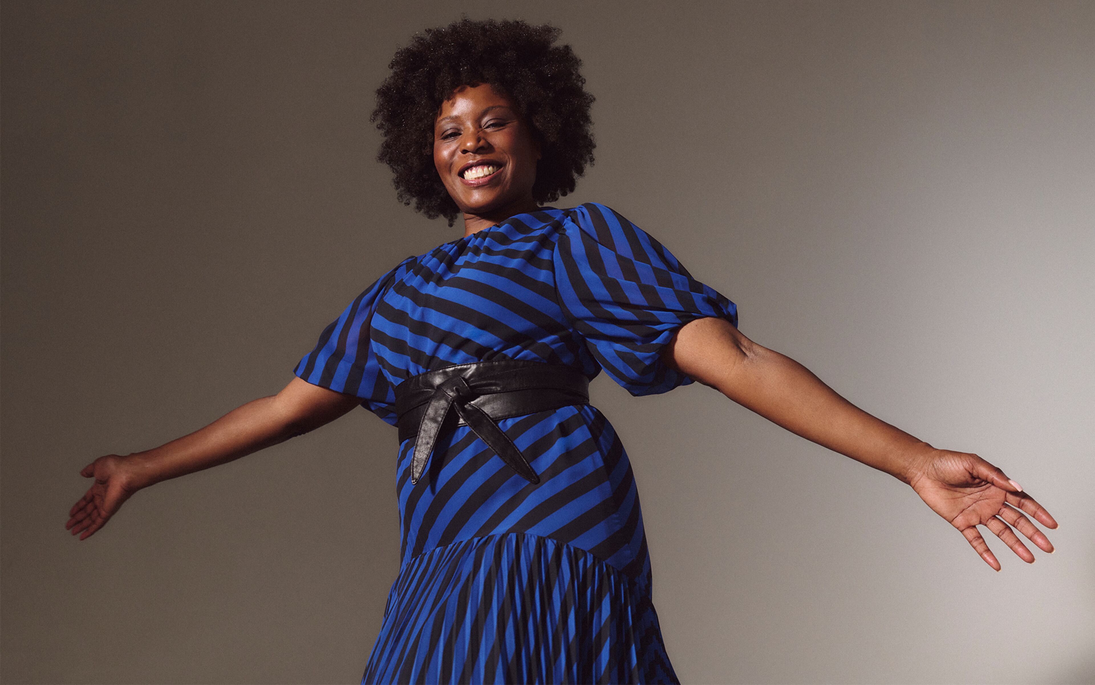A lady wearing a blue and black diagonal striped dress.