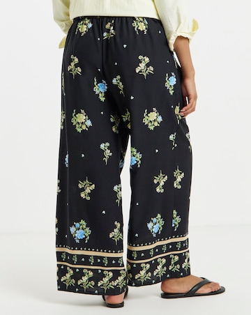 Simply Be Black Floral Border Print Wide Leg Trousers
