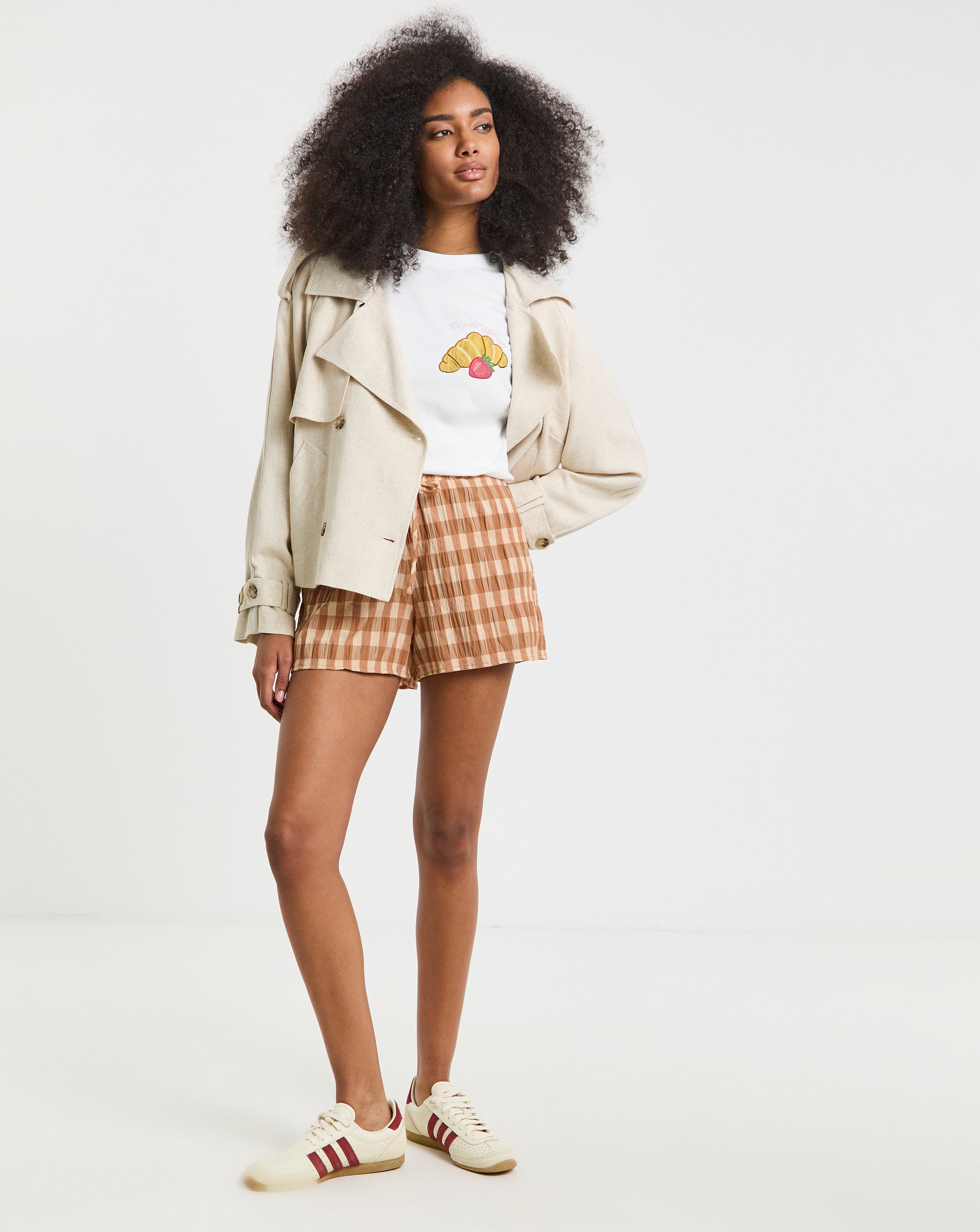 Model wears gingham check shorts