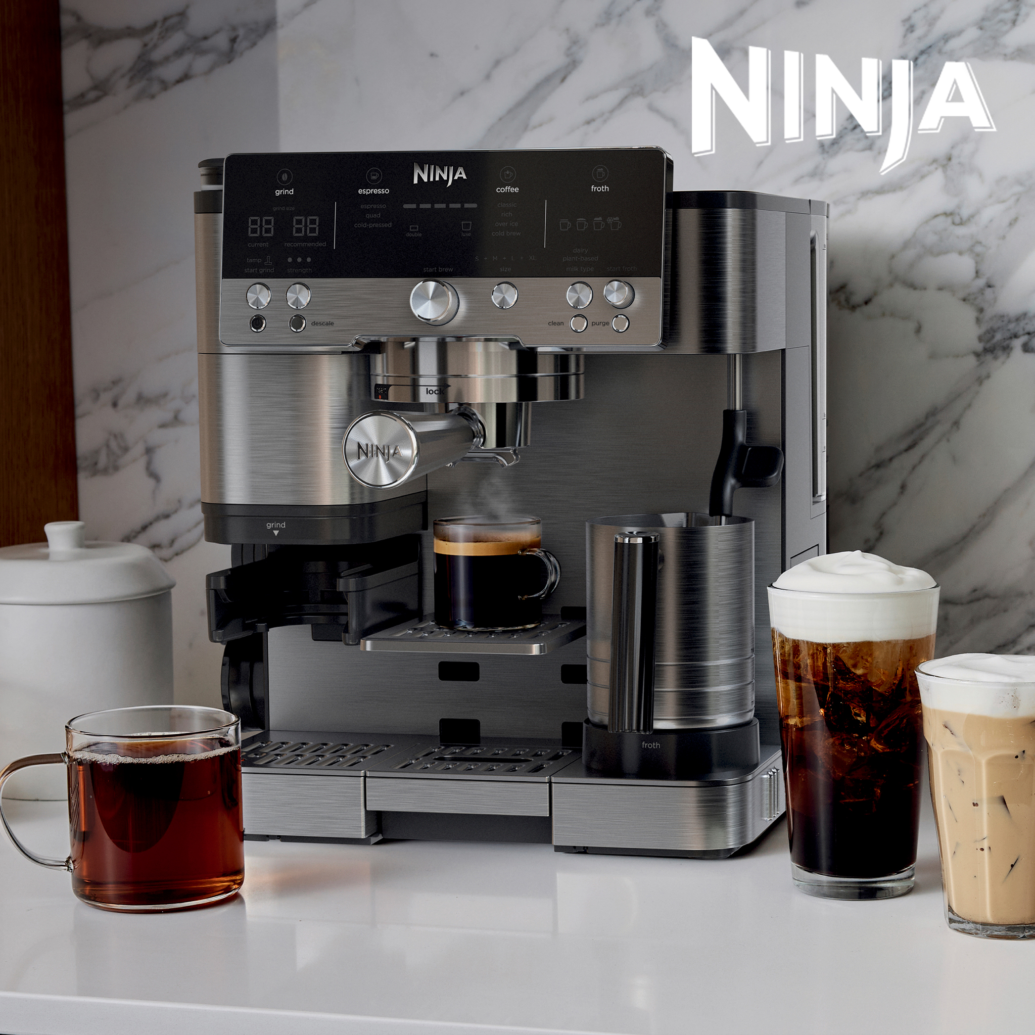 A stainless steel Ninja espresso machine with a built-in grinder and milk frother, surrounded by coffee drinks.