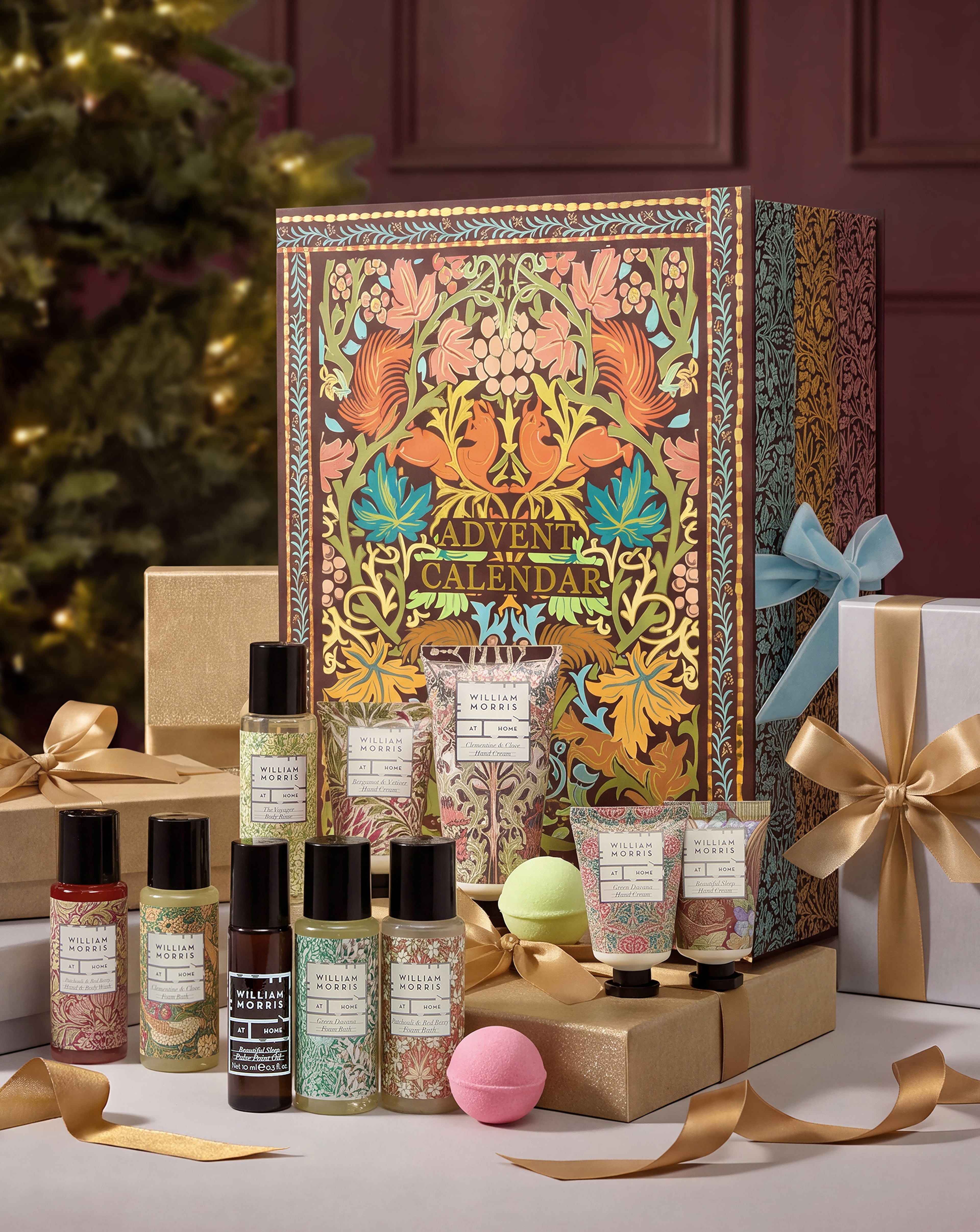 A William Morris At Home advent calendar surrounded by various miniature bath and body products.