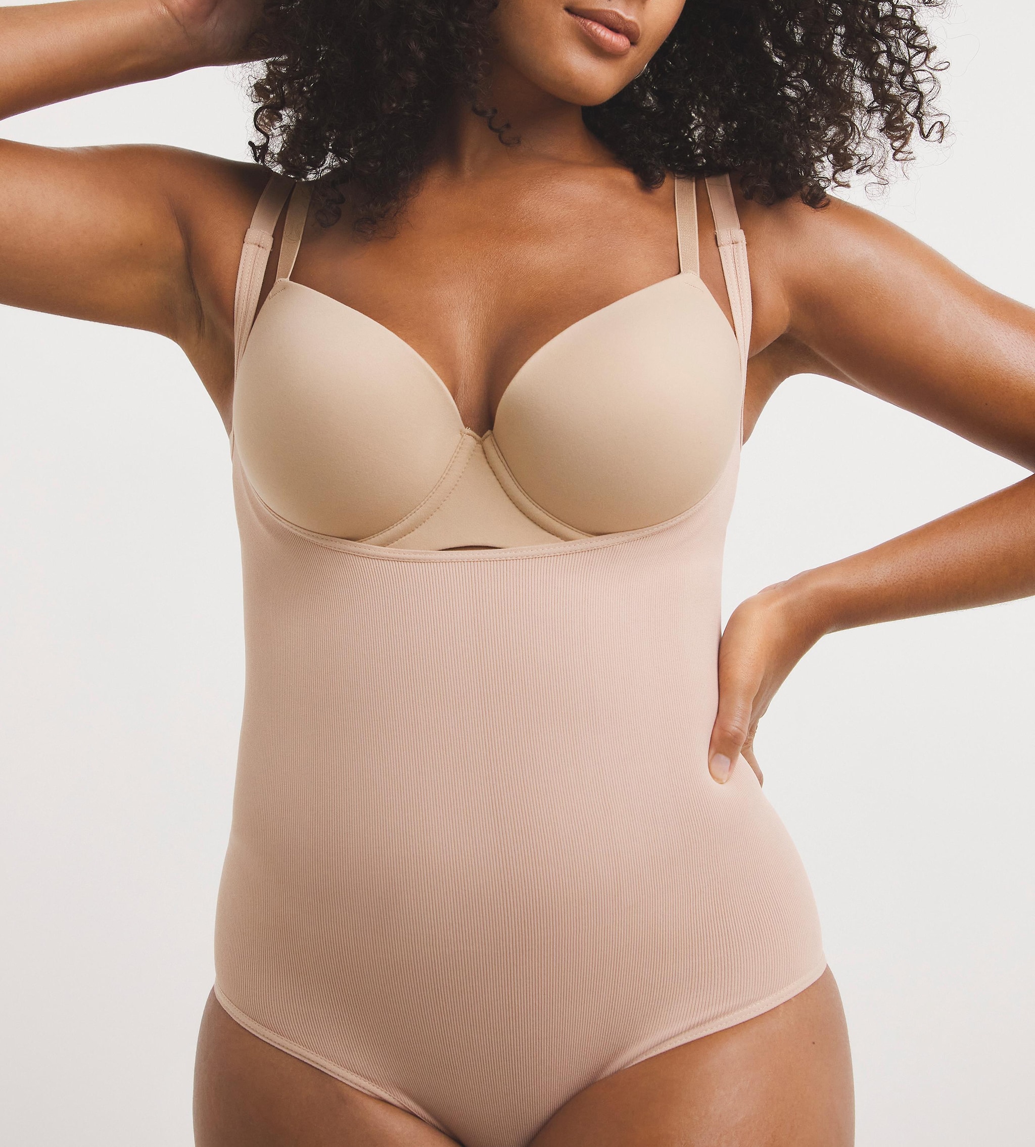 Lady wearing beige shapewear bodysuit