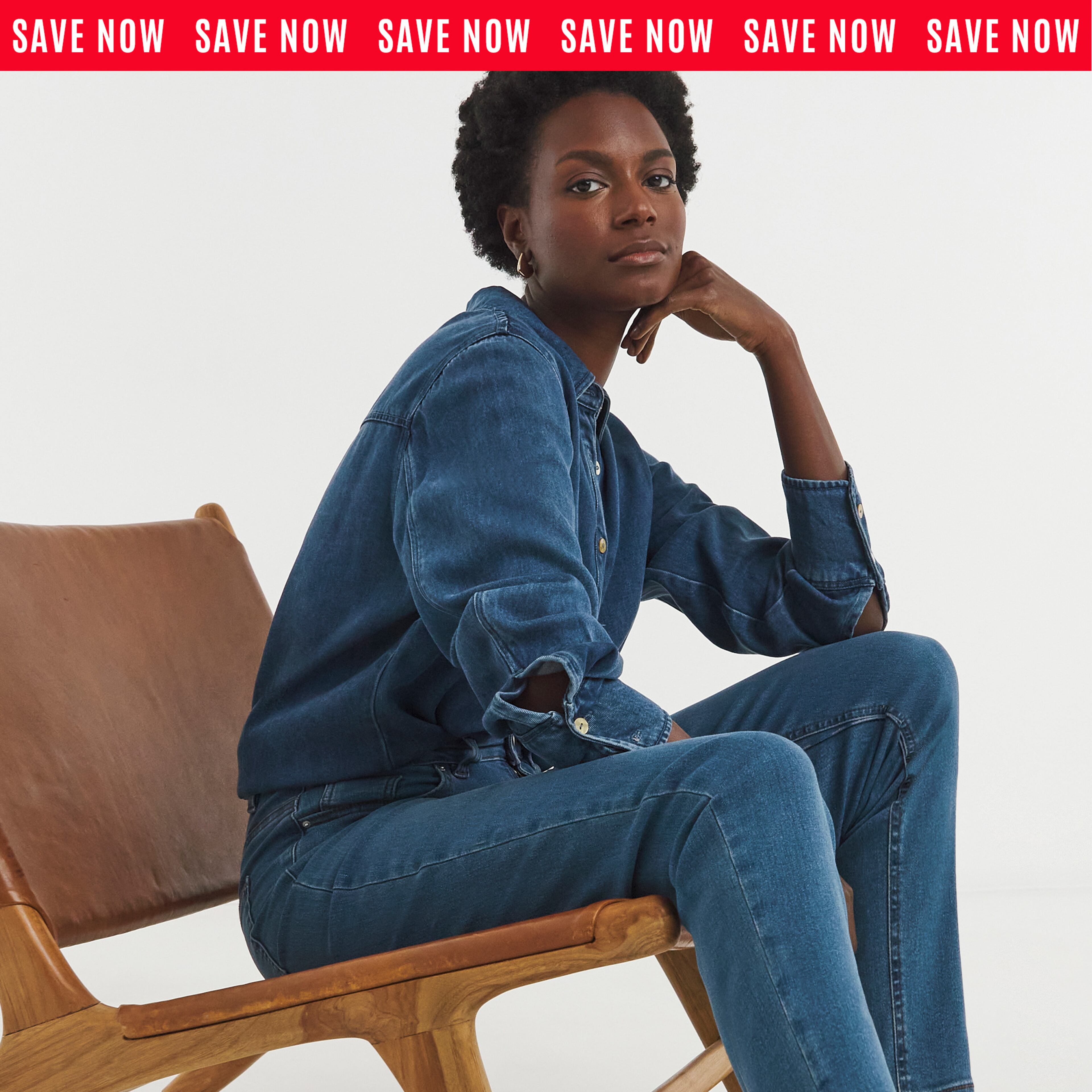 Model sat on chair wearing a denim shirt and denim jeans
