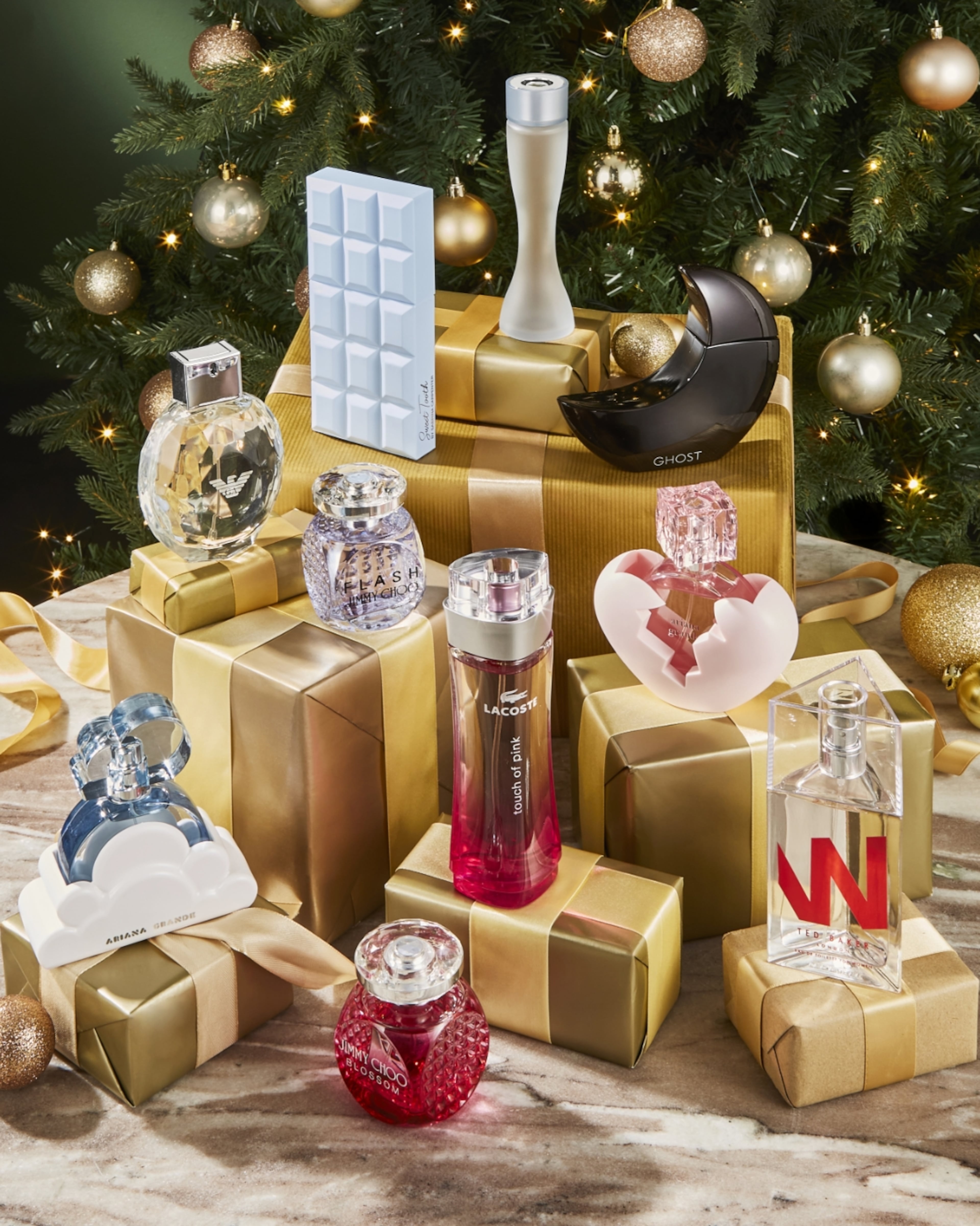 Luxurious Christmas Gift Scene With Perfume Bottles, Gold Boxes, Glitter Ornaments, And Decor