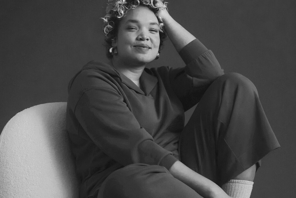 Black and white image of woman sat down in joggers