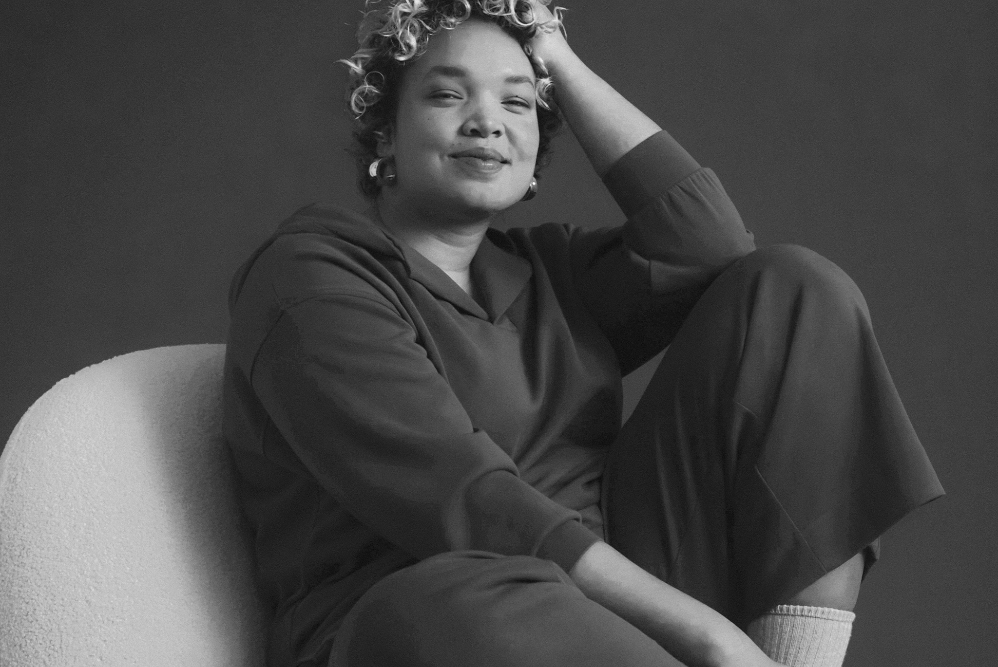 Black and white image of woman sat down in joggers