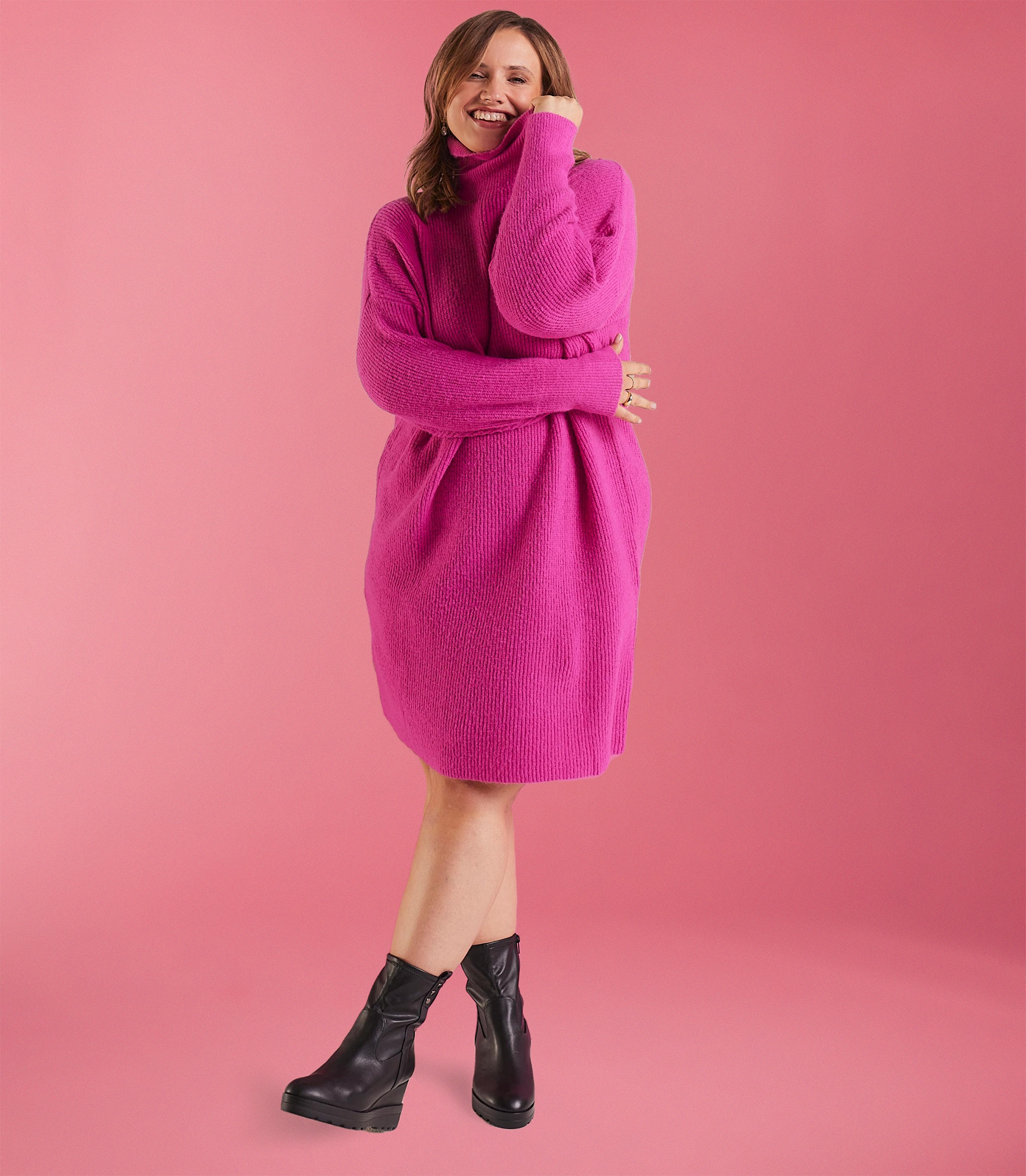 A woman stood wearing a pink fluffy dressing gown
