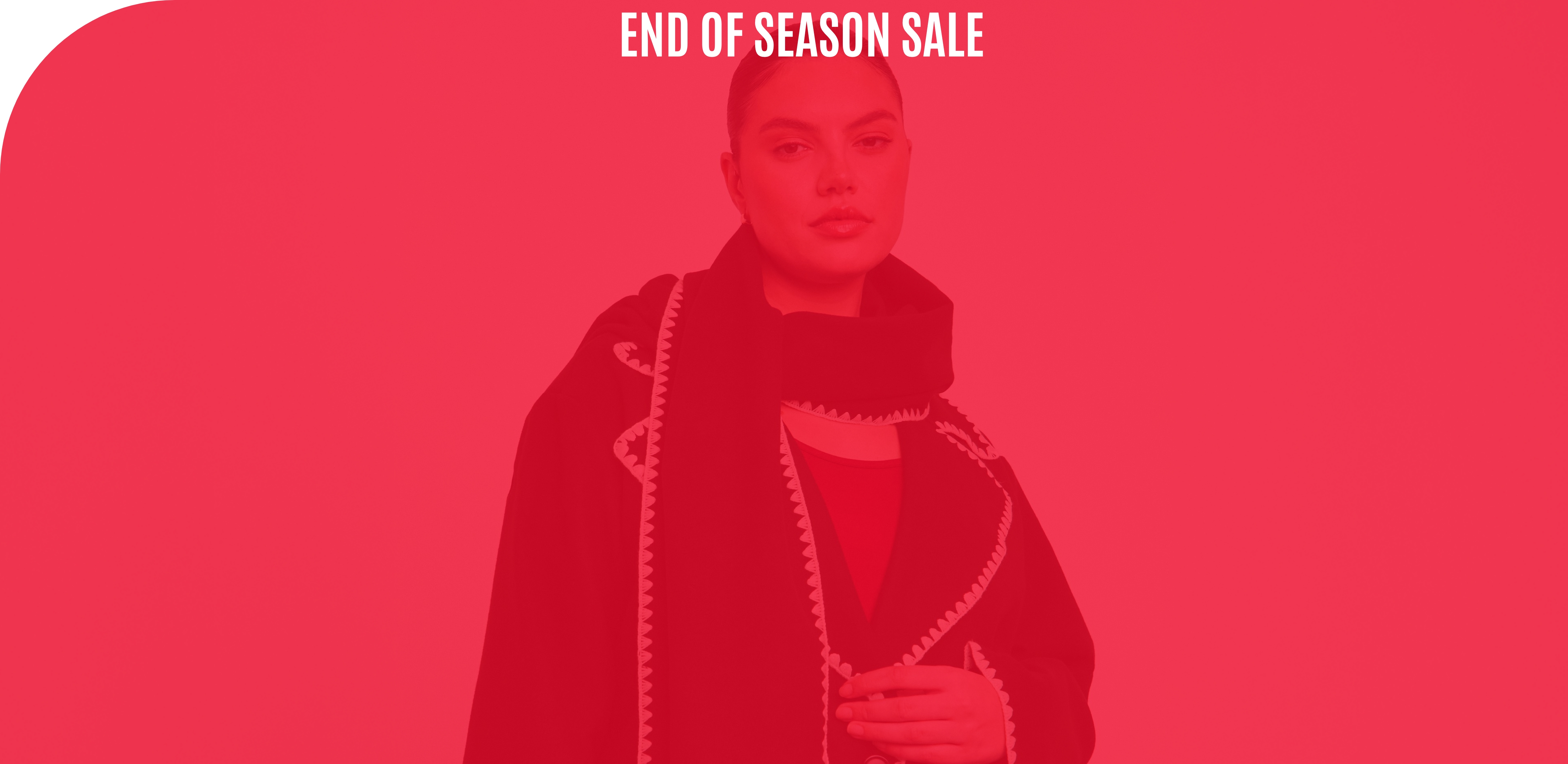 A woman in a black coat with white embroidery and a matching scarf, viewed through a heavy red color overlay. The text end of season sale is centered at the top.