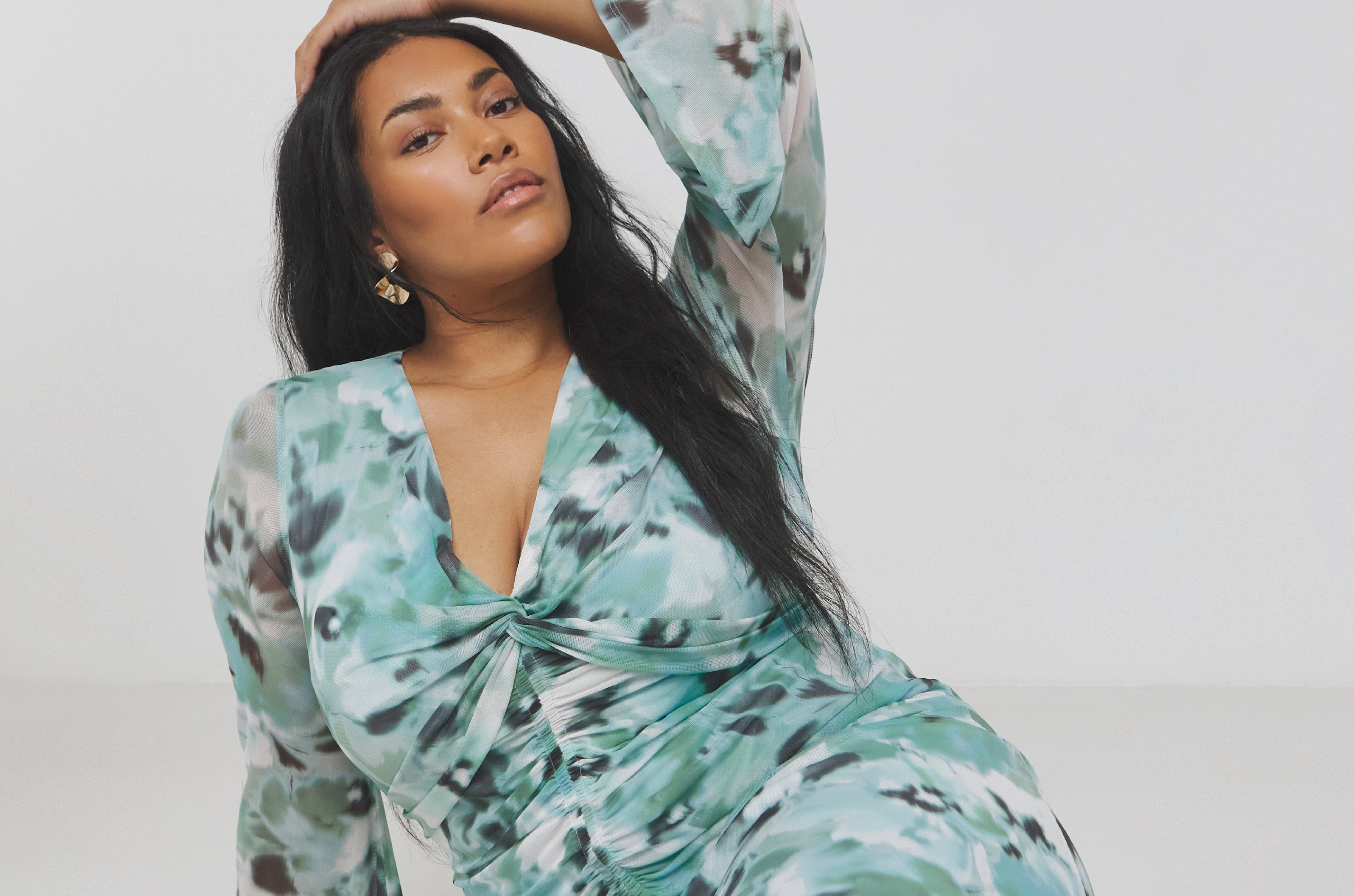 Stylish Woman Posing in Elegant Patterned Dress With Confidence and Grace