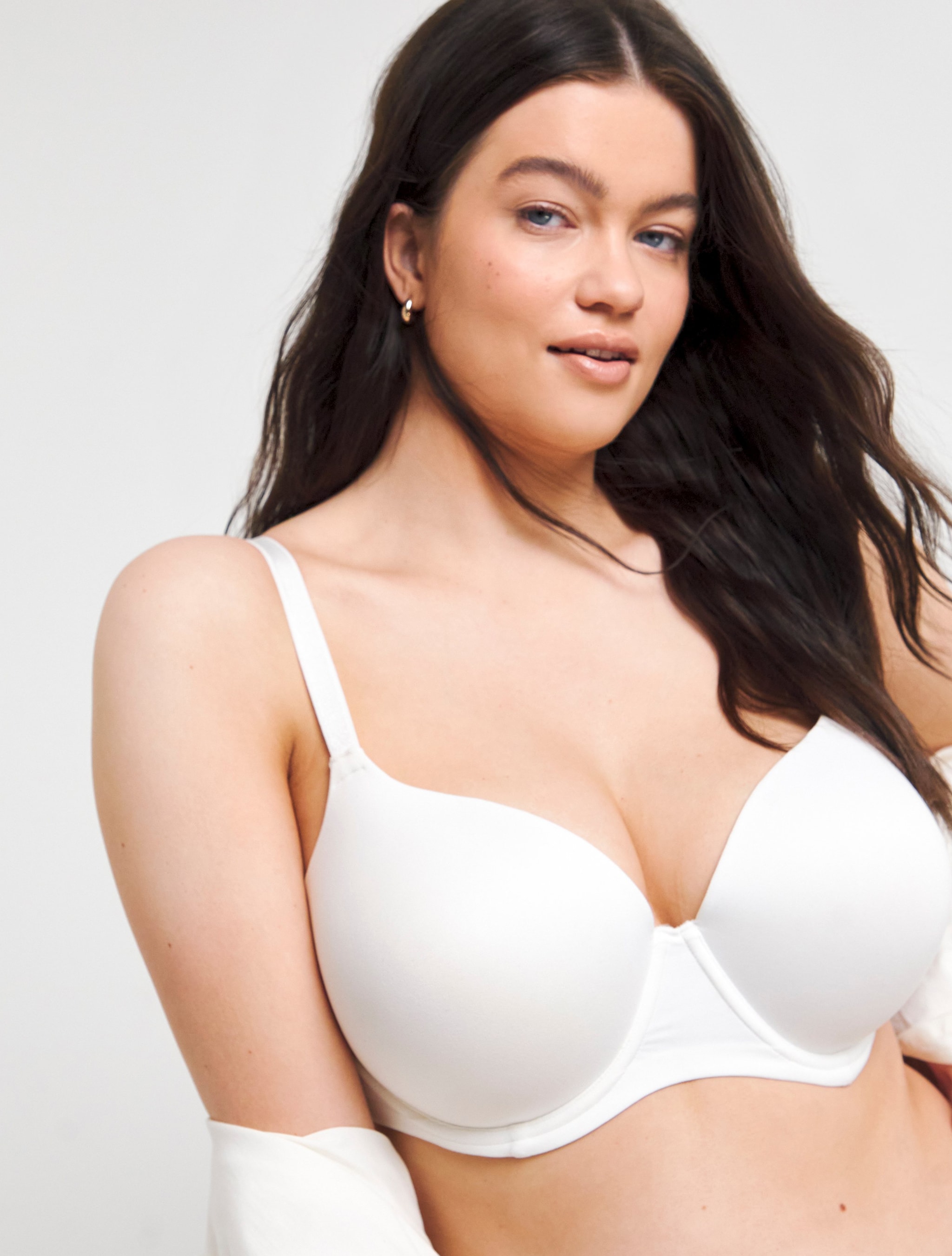 A woman wearing a white t-shirt bra