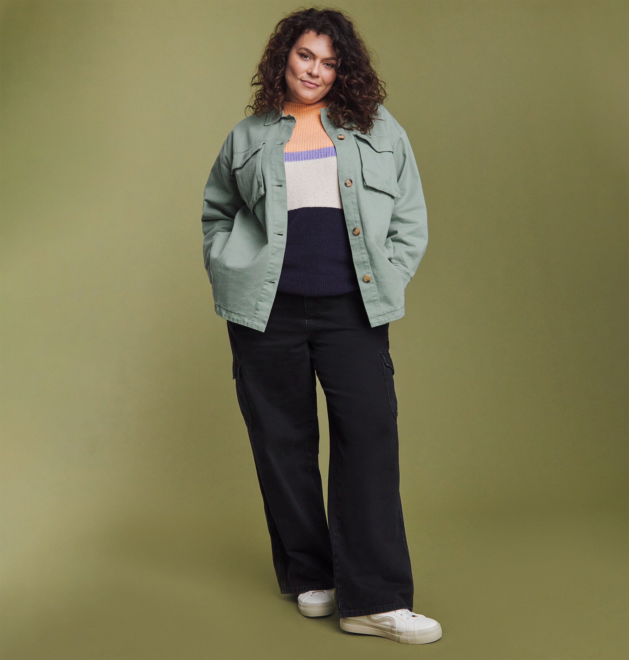 A woman wearing denim jacket and wide fit black trousers