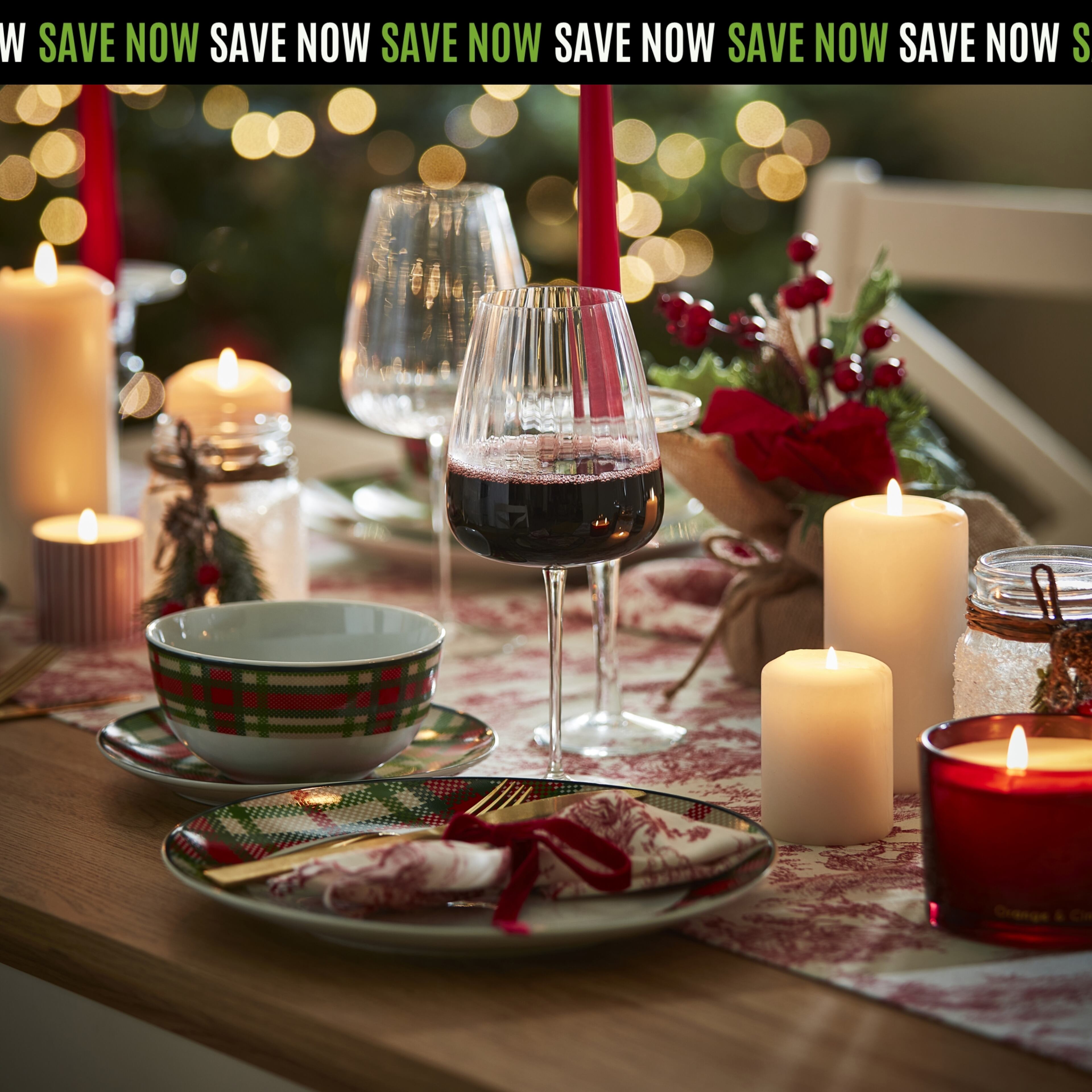 Festive Christmas Dinner Table Setting with Candles and Wine