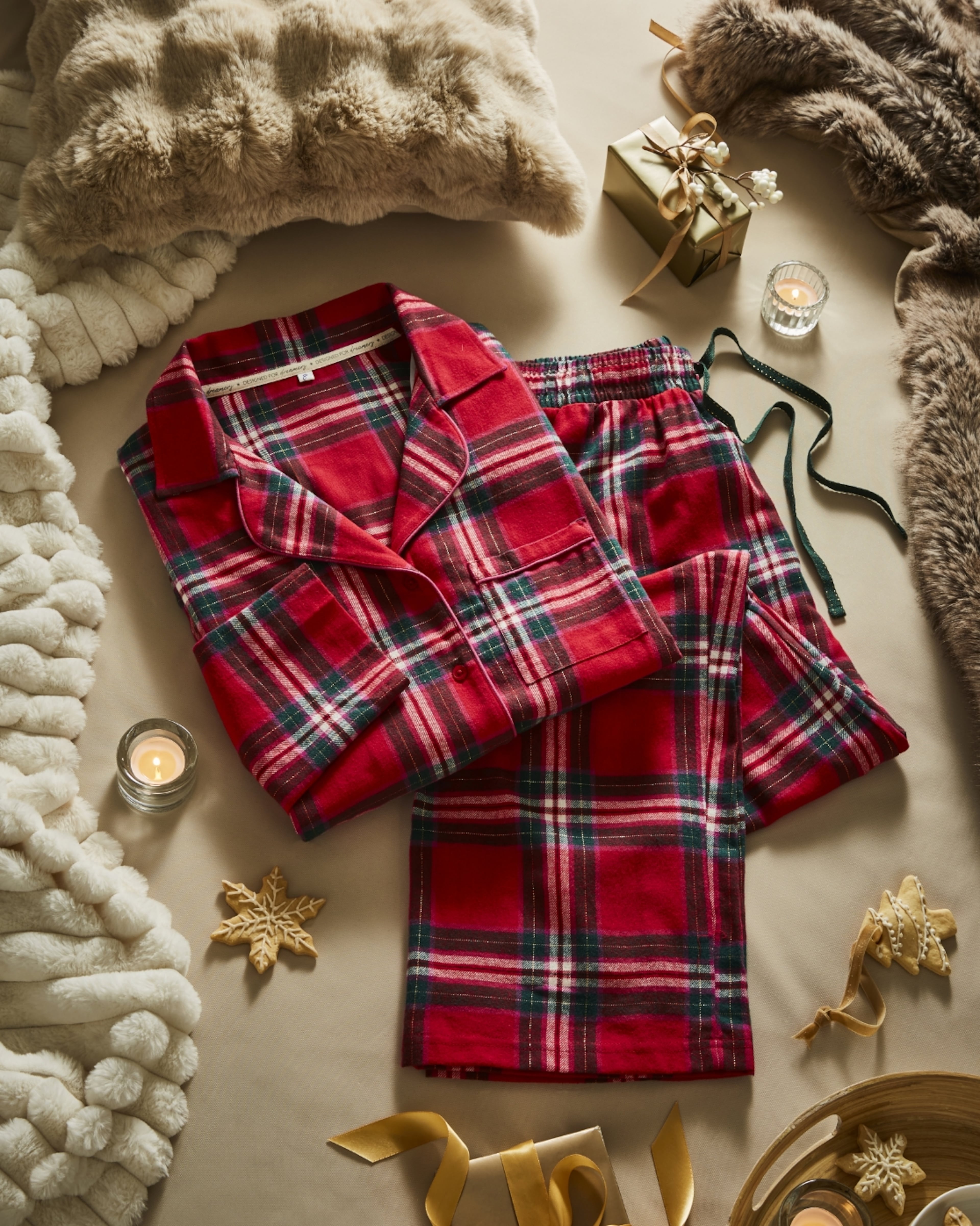 Cozy Winter Plaid Pajama Set With Plush Blankets, Gifts, and Candles in a Holiday Scene