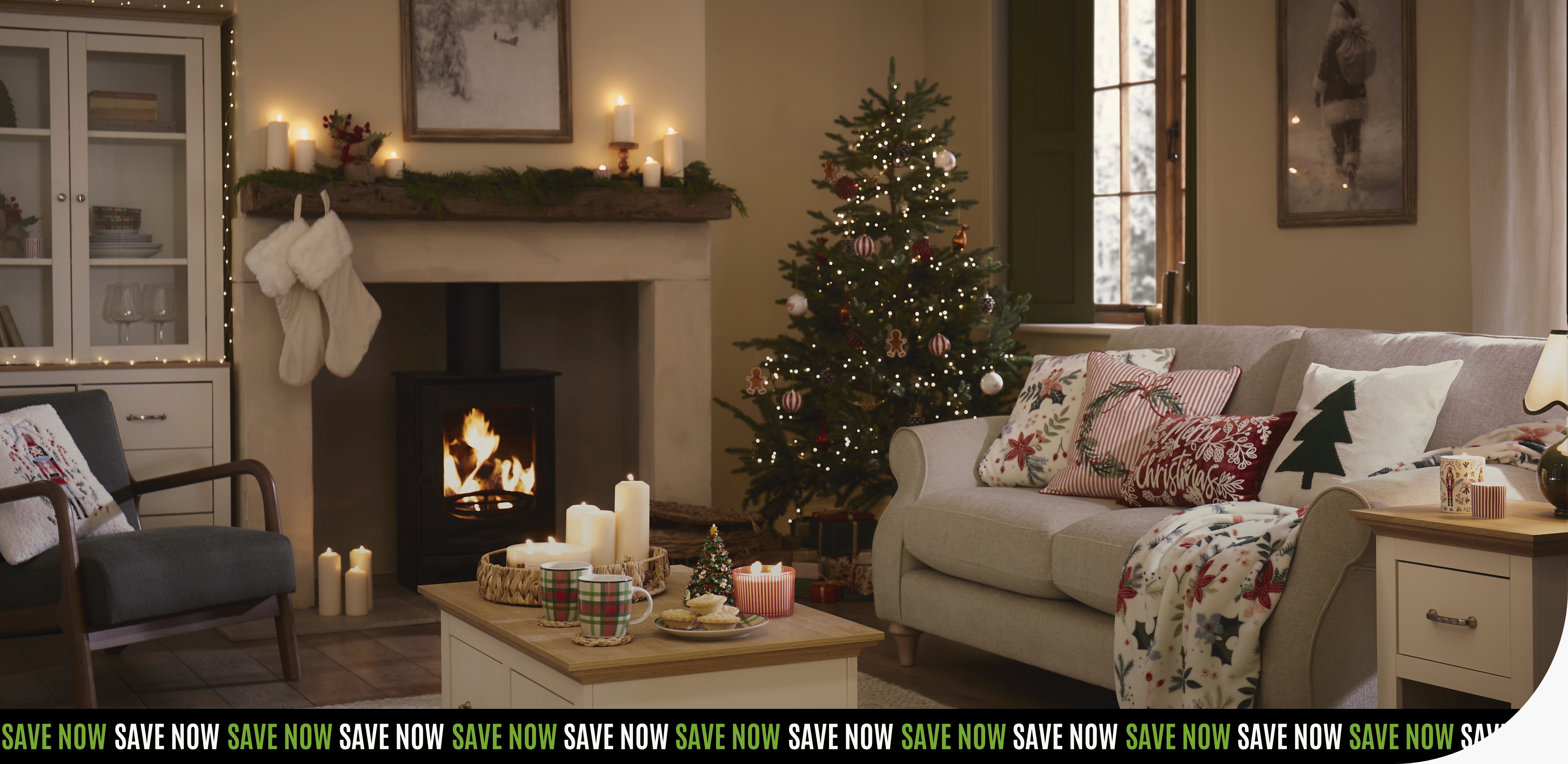 A living room with a lit fireplace, stockings hanging on the mantel, and a decorated Christmas tree.