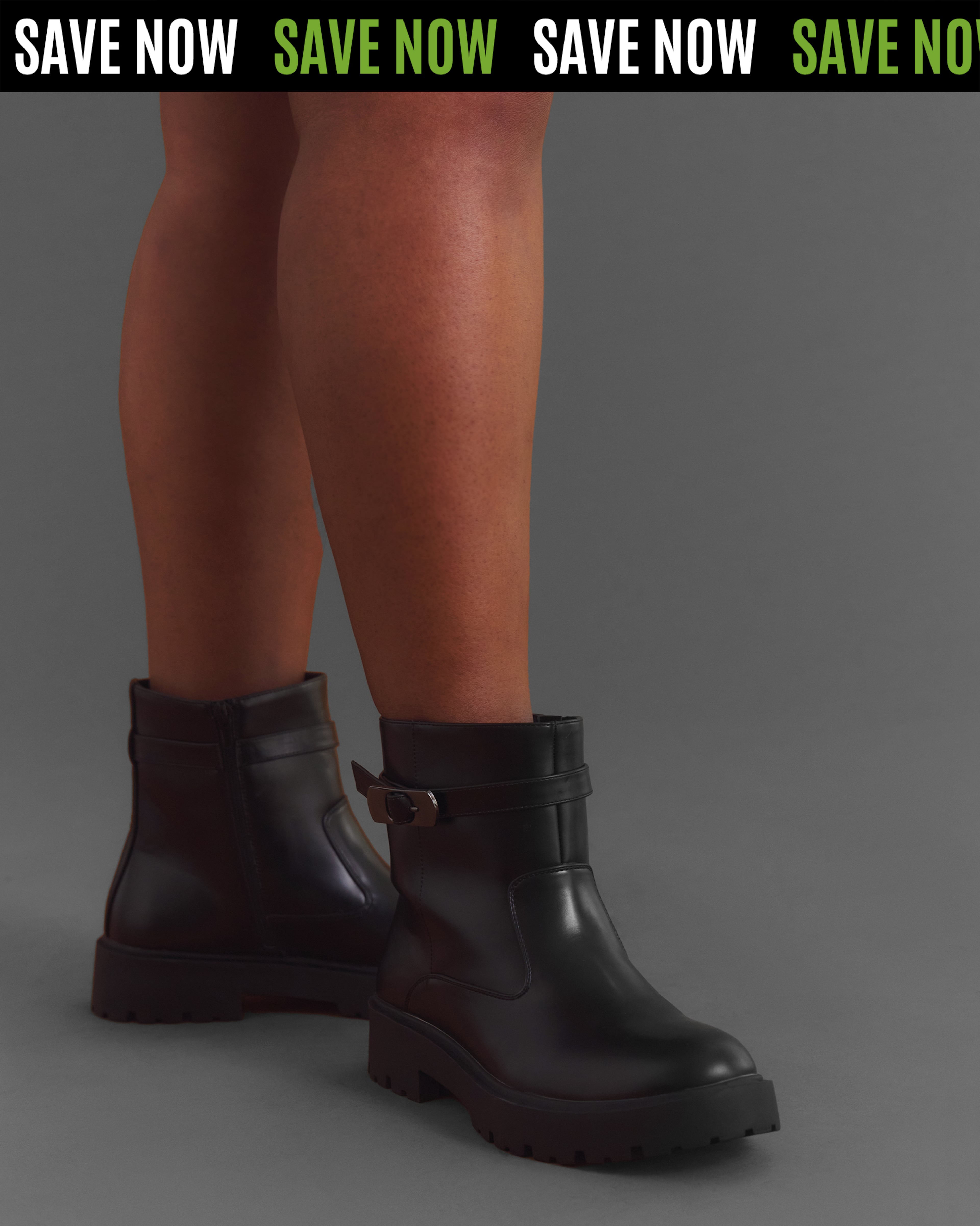 Close-up of black ankle boots with chunky soles and side buckle detail.