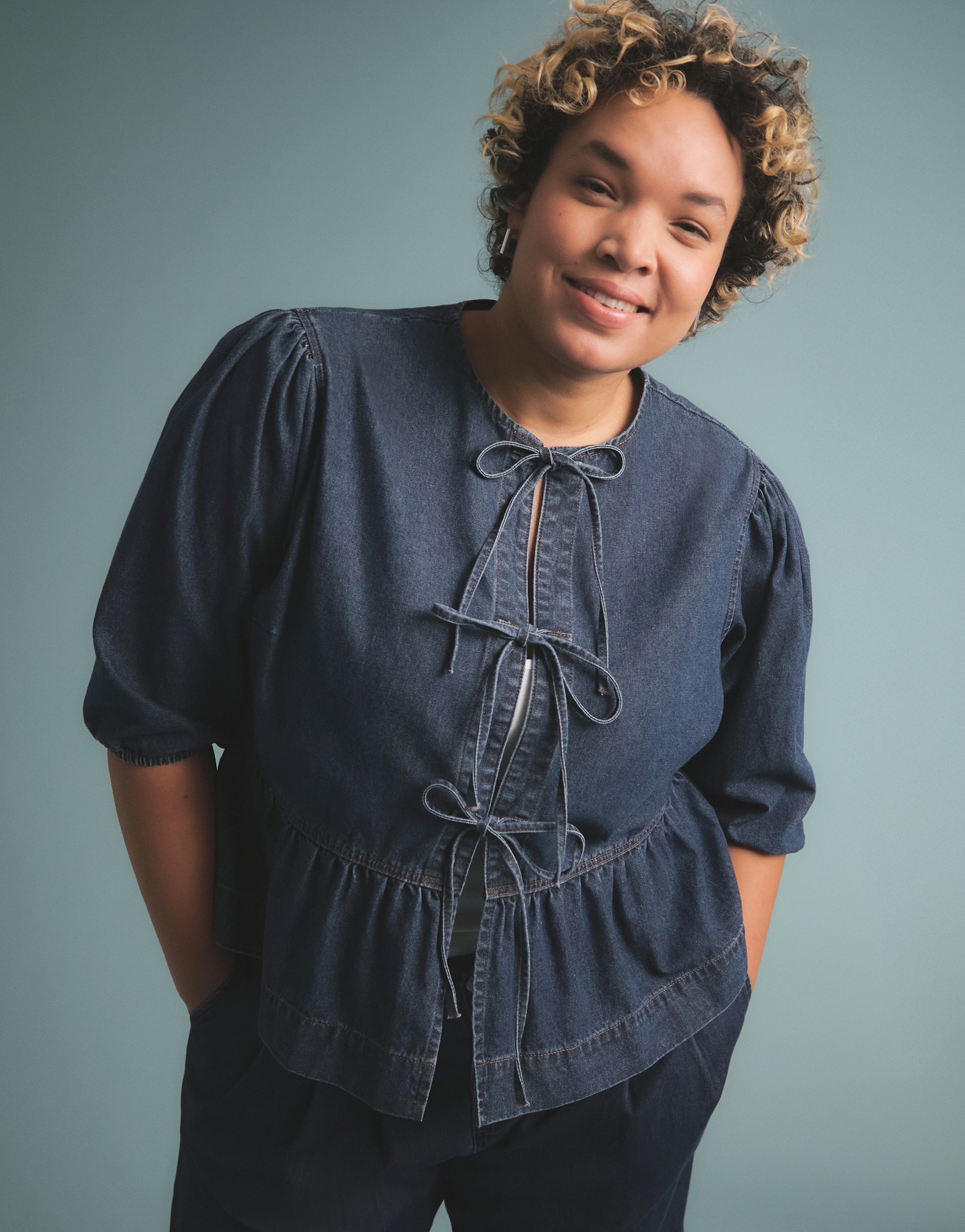 A woman wearing a dark blue blouse