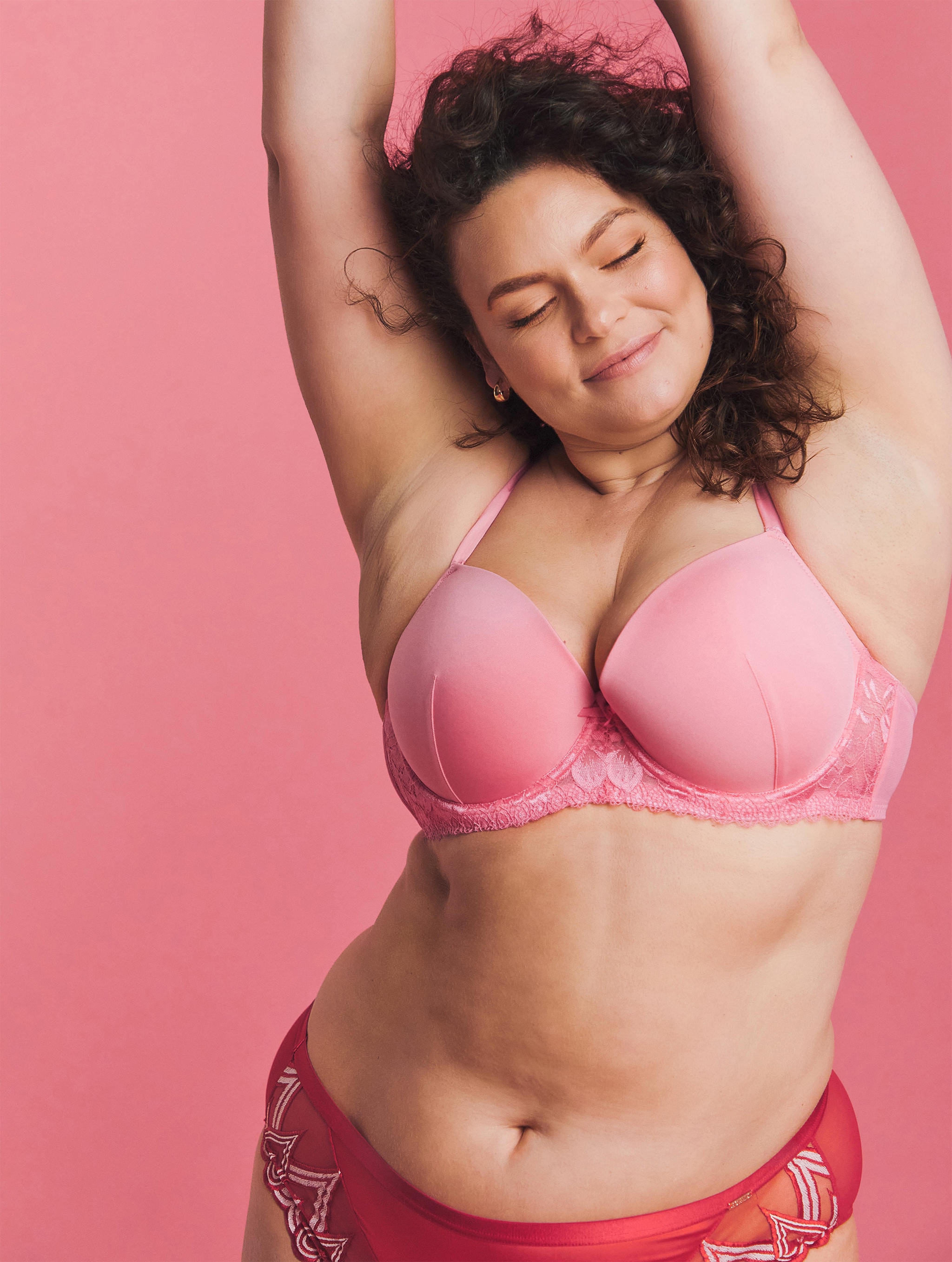 A woman wearing a pink bra and cerise knickers
