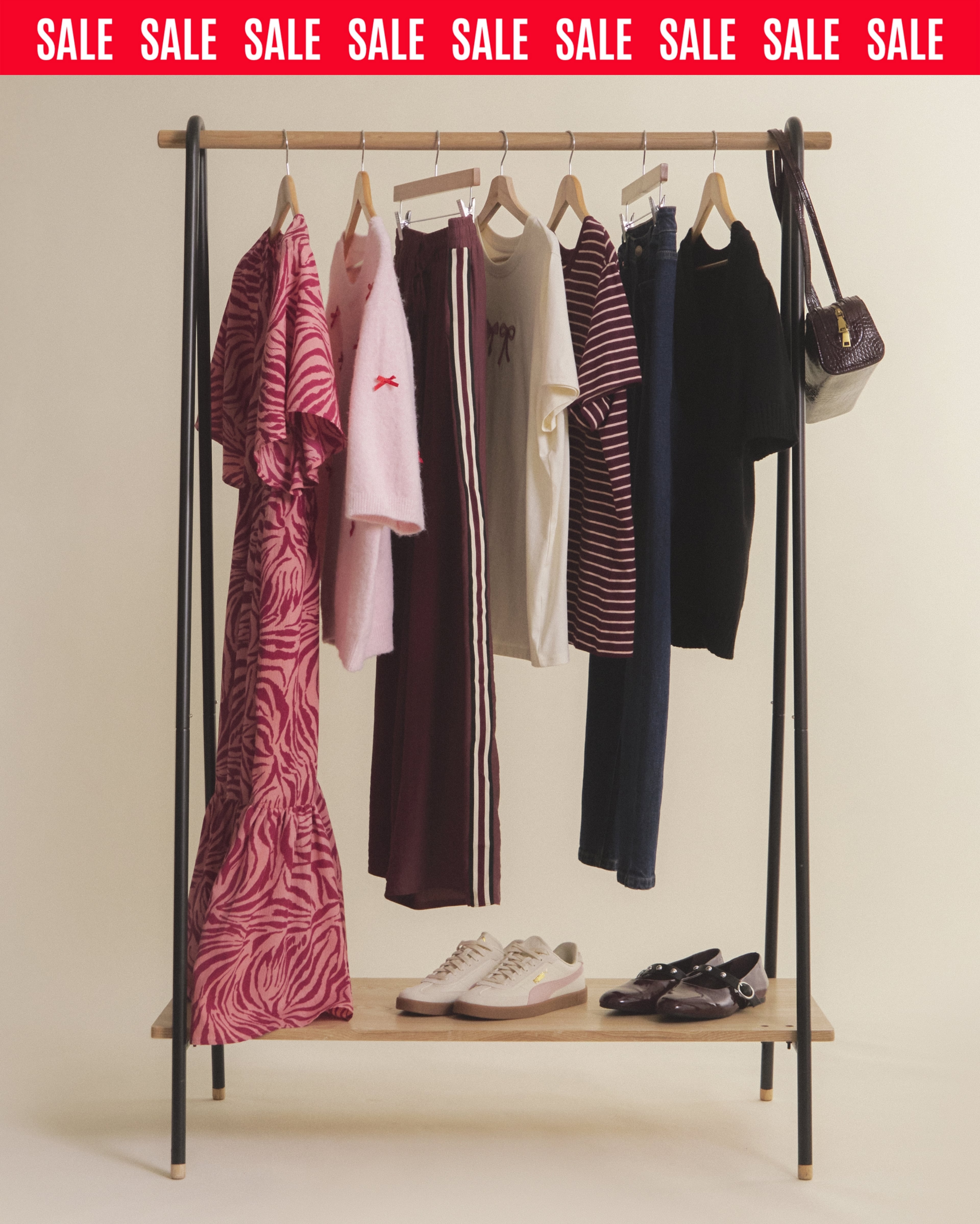 Fashion Rack With Clothes On Sale Banner Showcasing Women's Wardrobe, Shoes, and Bag