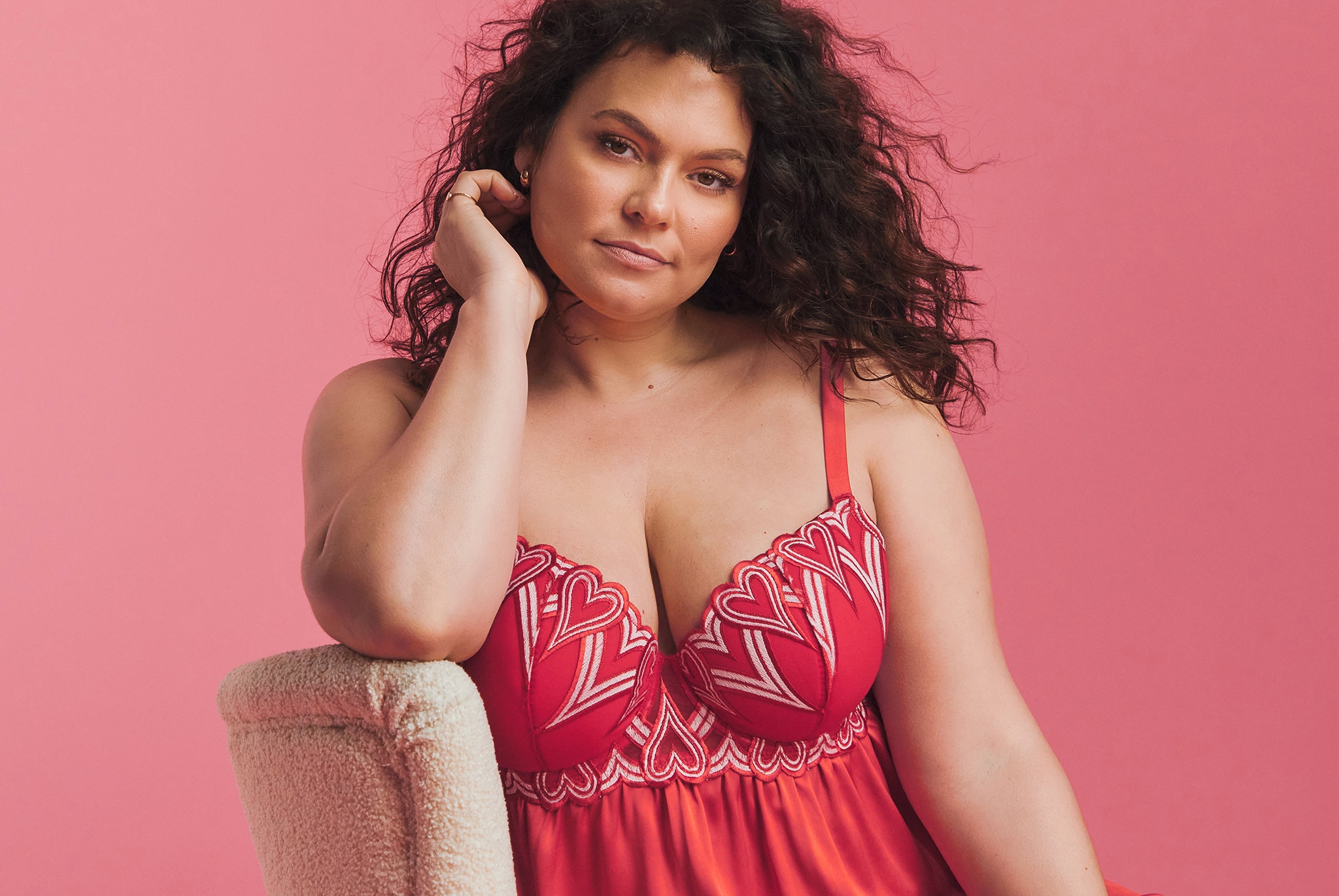 A woman wearing a red lacy camisole