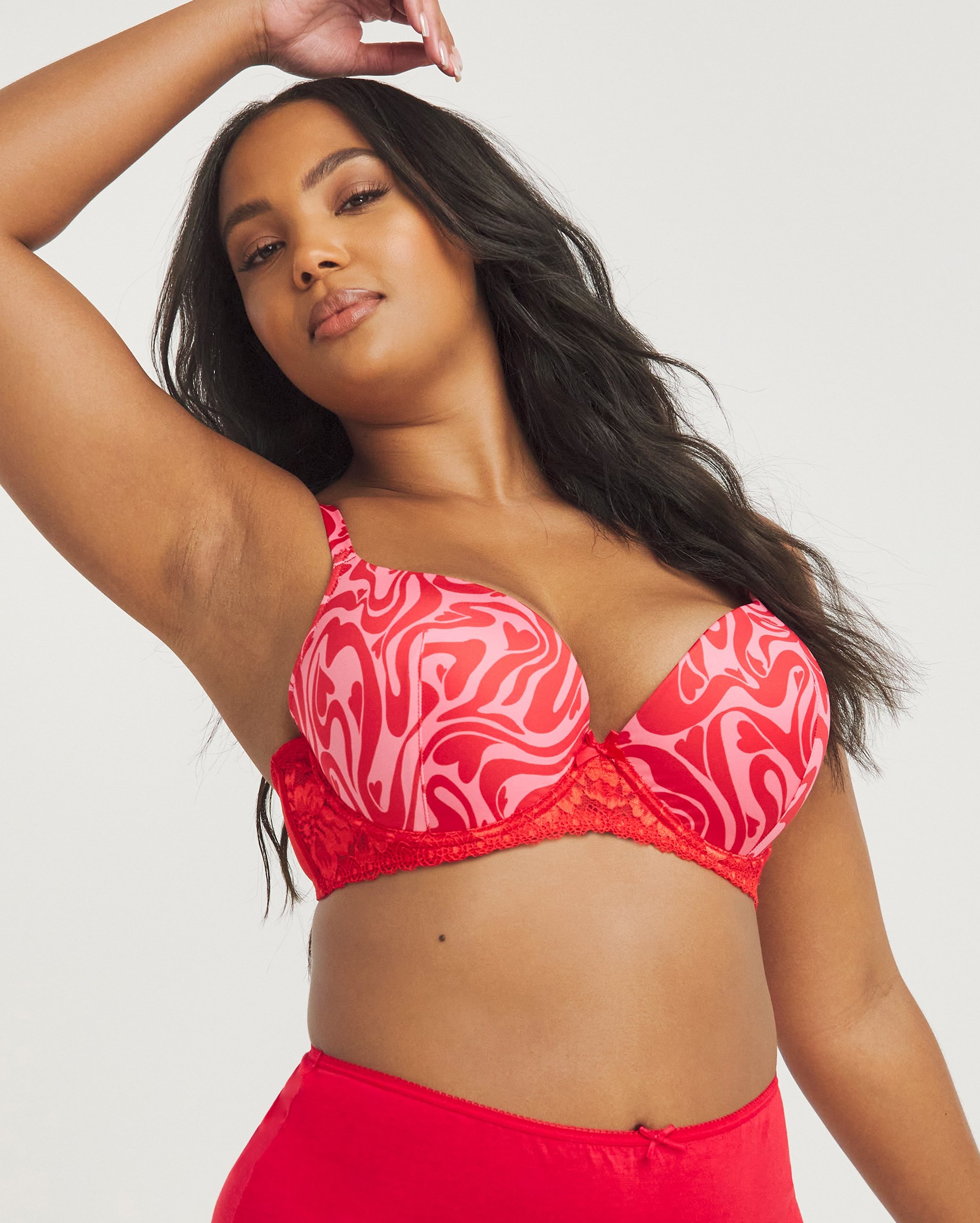 A woman wearing red patterned soft plunge bra